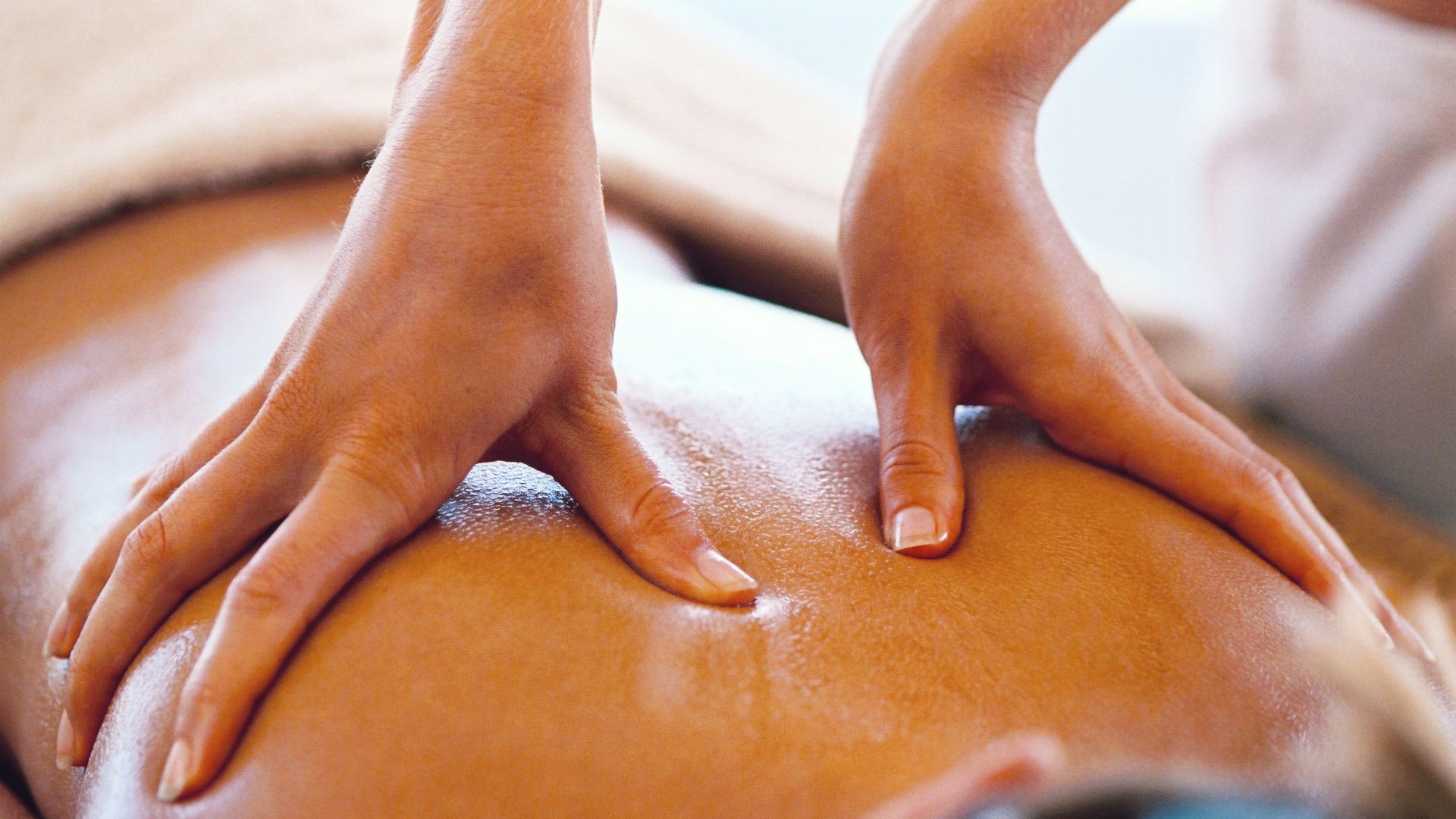 A person receiving a soothing back massage in a tranquil spa environment, promoting relaxation and well-being.